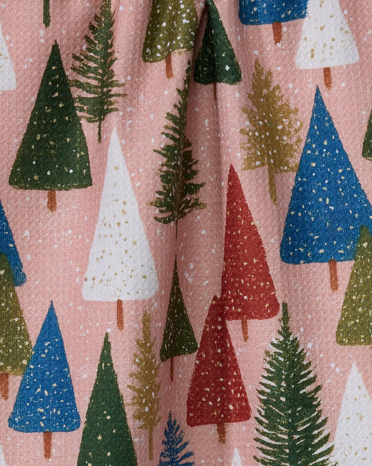 Tea towel close-up with colorful pine, blue and red tree pattern on pink