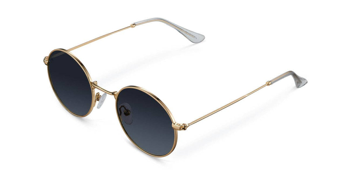 Round gold-tone sunglasses with dark lenses, slim metal frame and curved temple arms