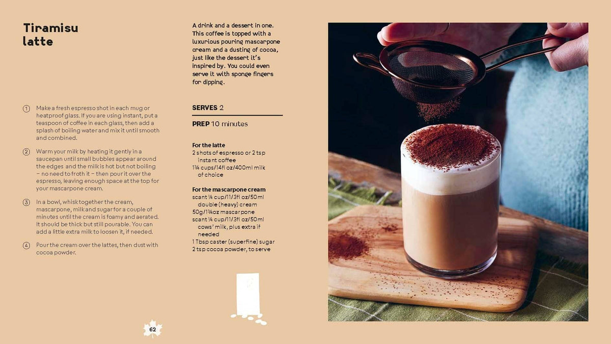 Creamy tiramisu latte in a glass mug with cocoa-dusted top