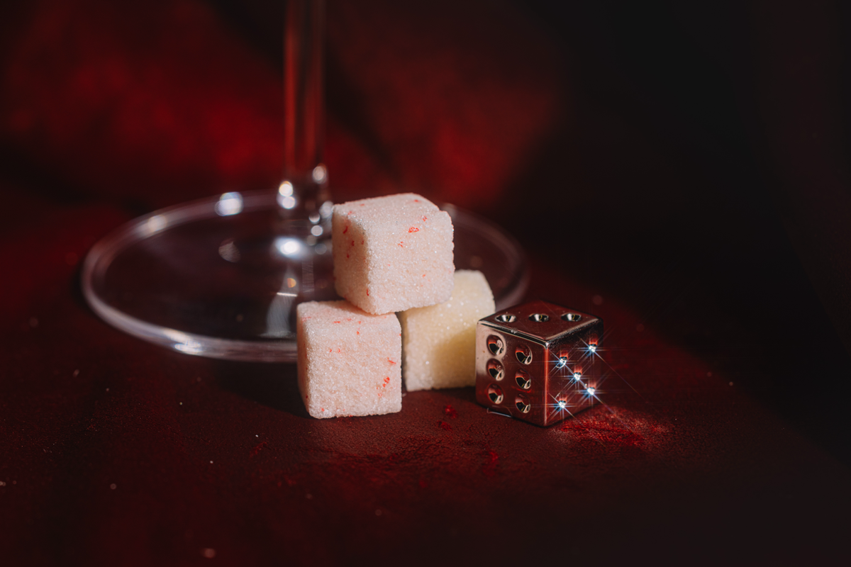 Cubed white and pink candies with a martini glass and sprinkle topping