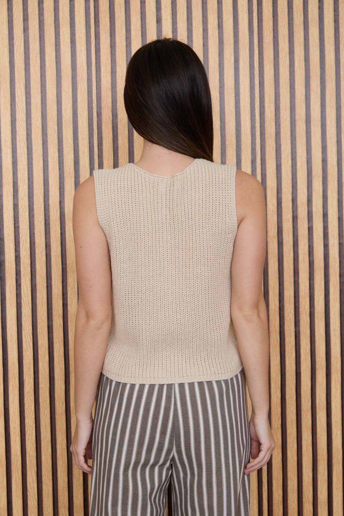 Beige sleeveless cardigan vest, back view, knit texture and rounded neckline