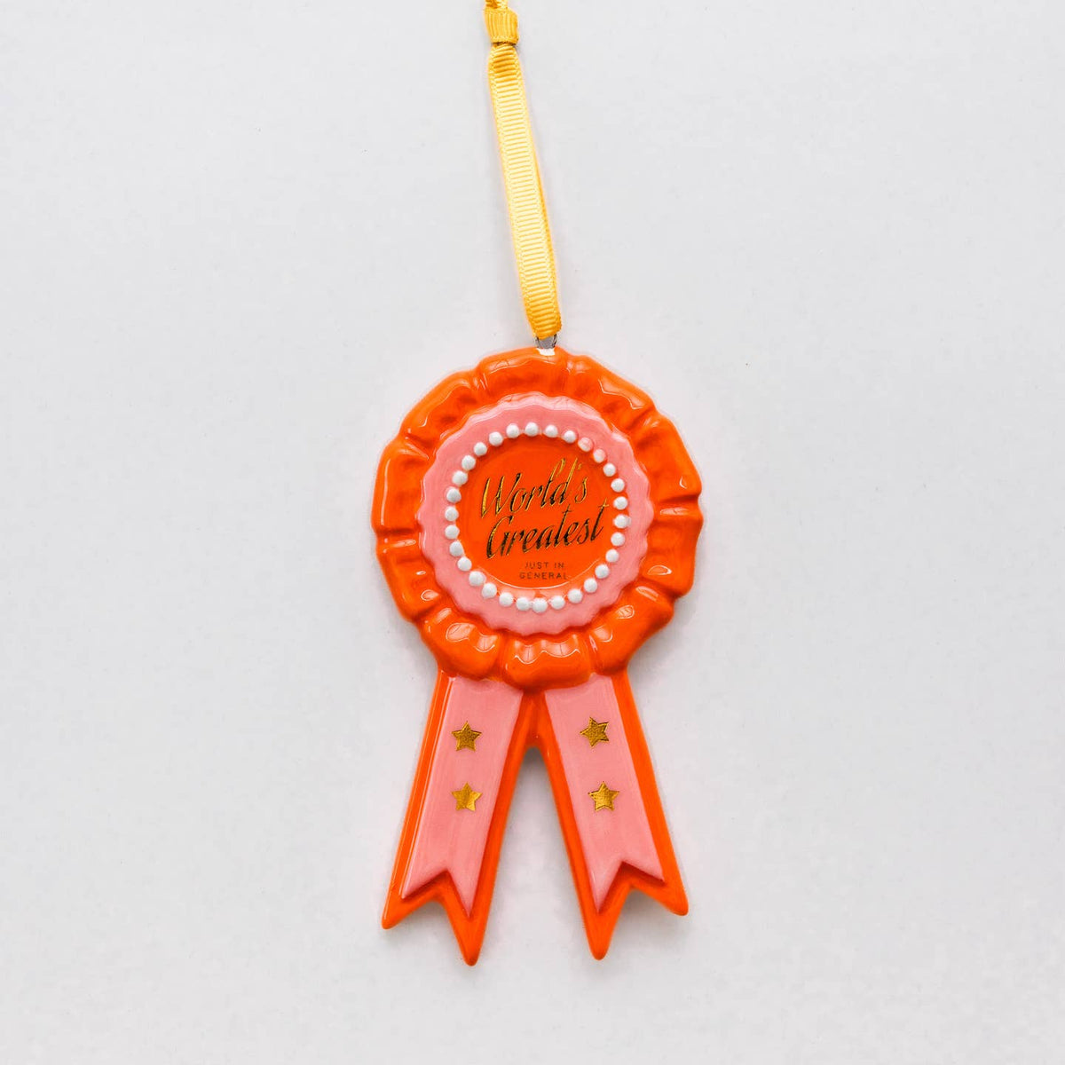 Orange rosette holiday ornament with pink ribbon and yellow hanging cord, beaded edge