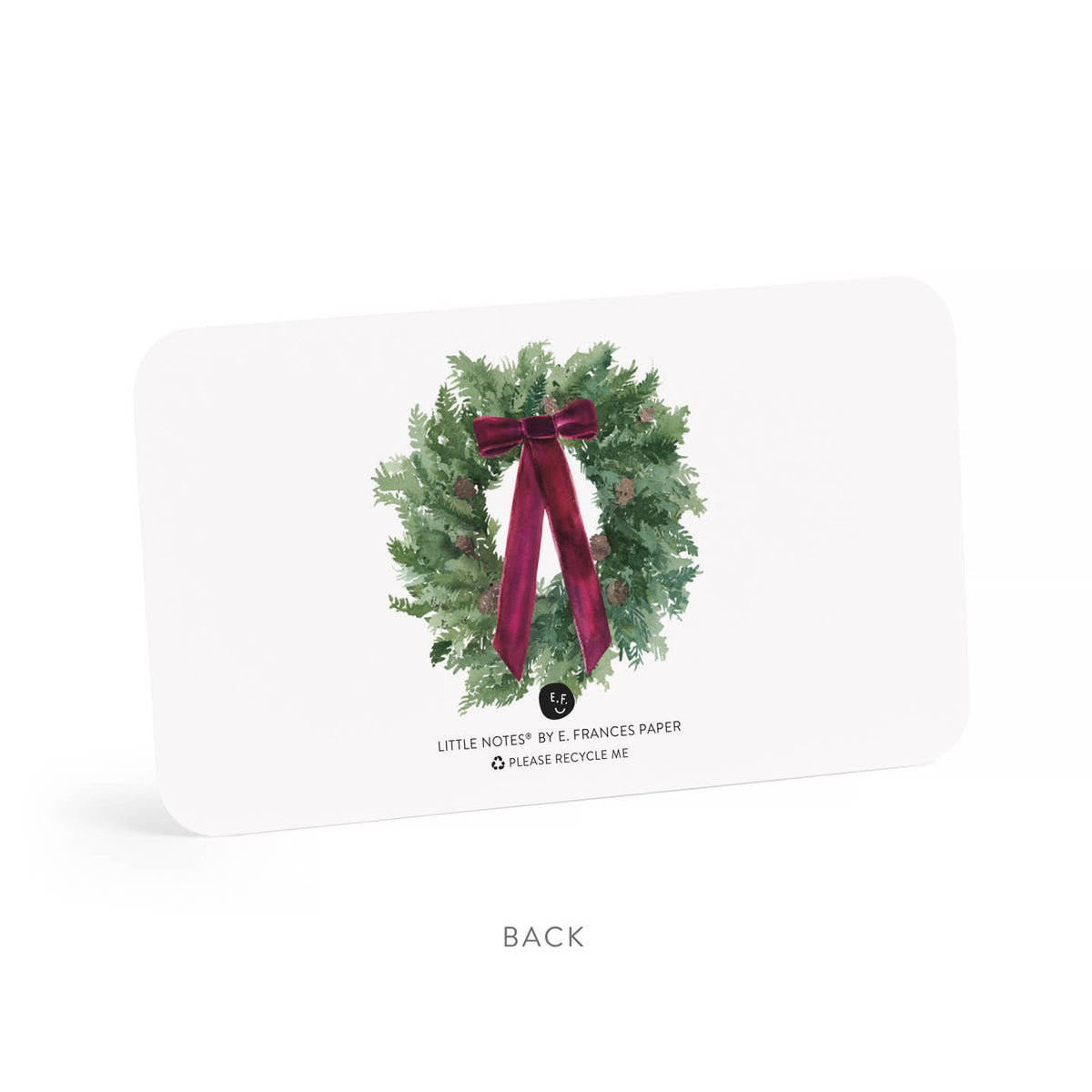 Back of Christmas note cards with illustrated wreath, red bow, and small recycle text