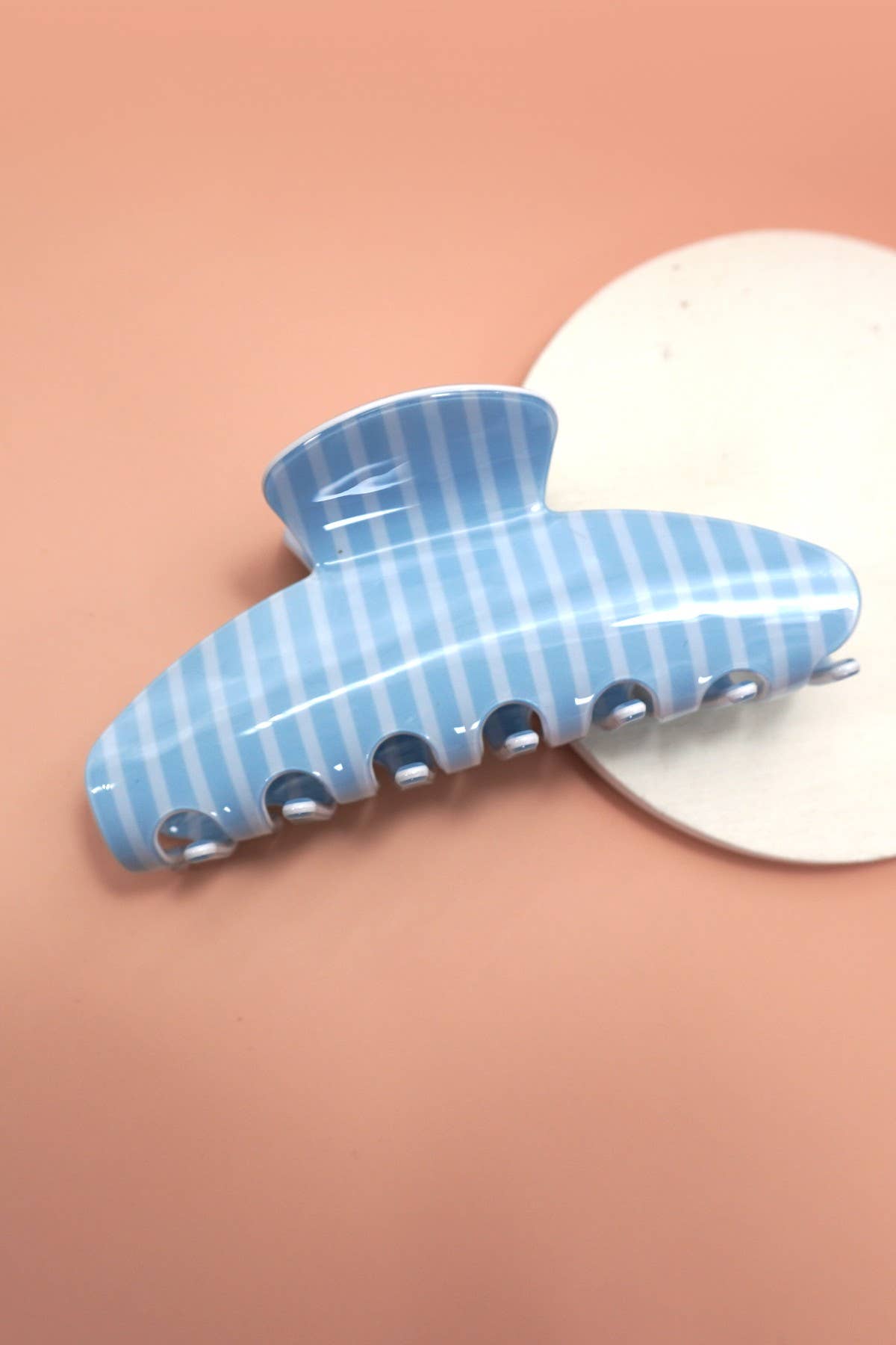 Light blue striped oval jumbo hair claw clip with silver teeth.