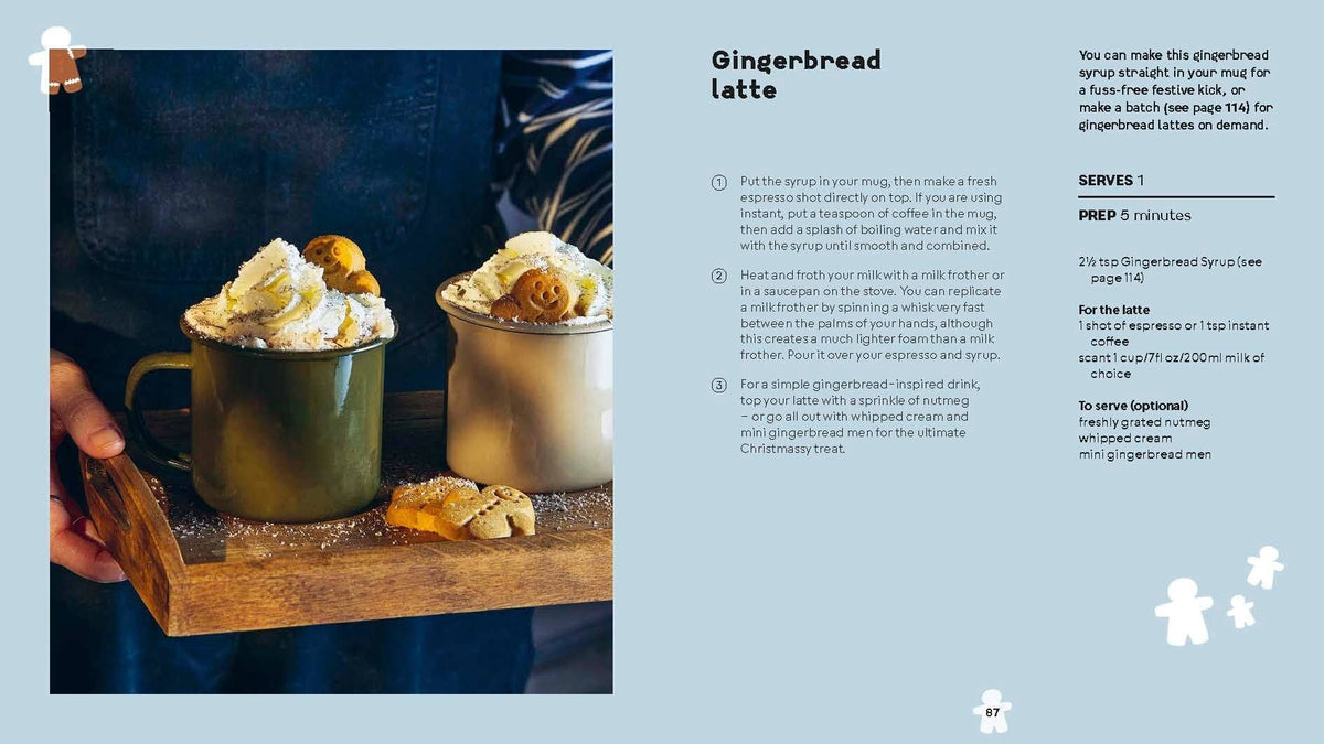 Gingerbread latte in two cups with whipped cream and small pastry garnish