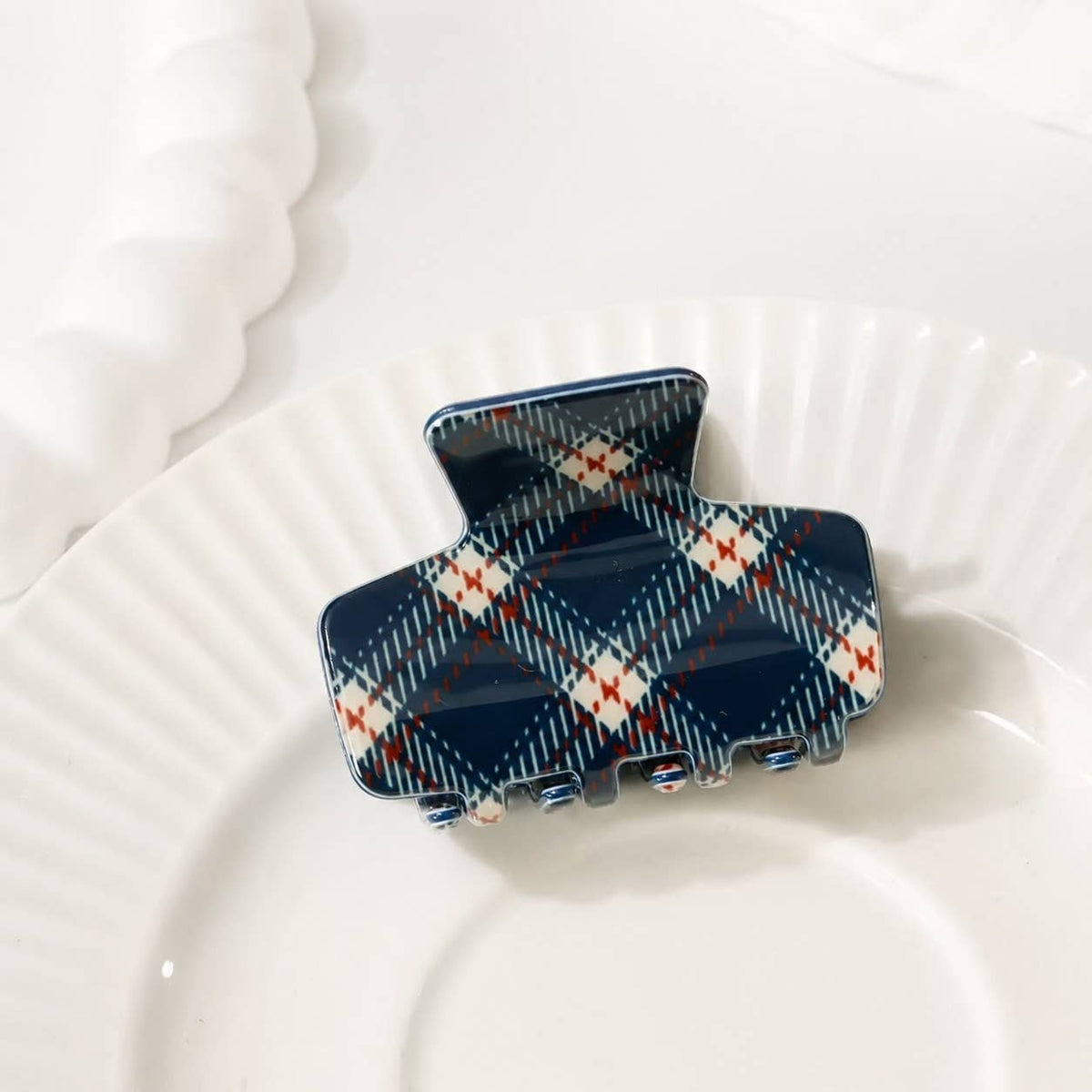 Plaid hair claw clip in navy with orange and light accents