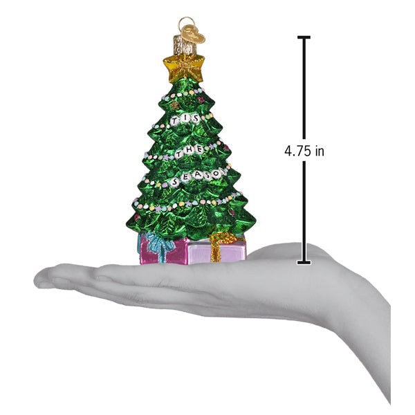 Green glitter Christmas tree ornament on hand for scale, 4.75 in hanging height