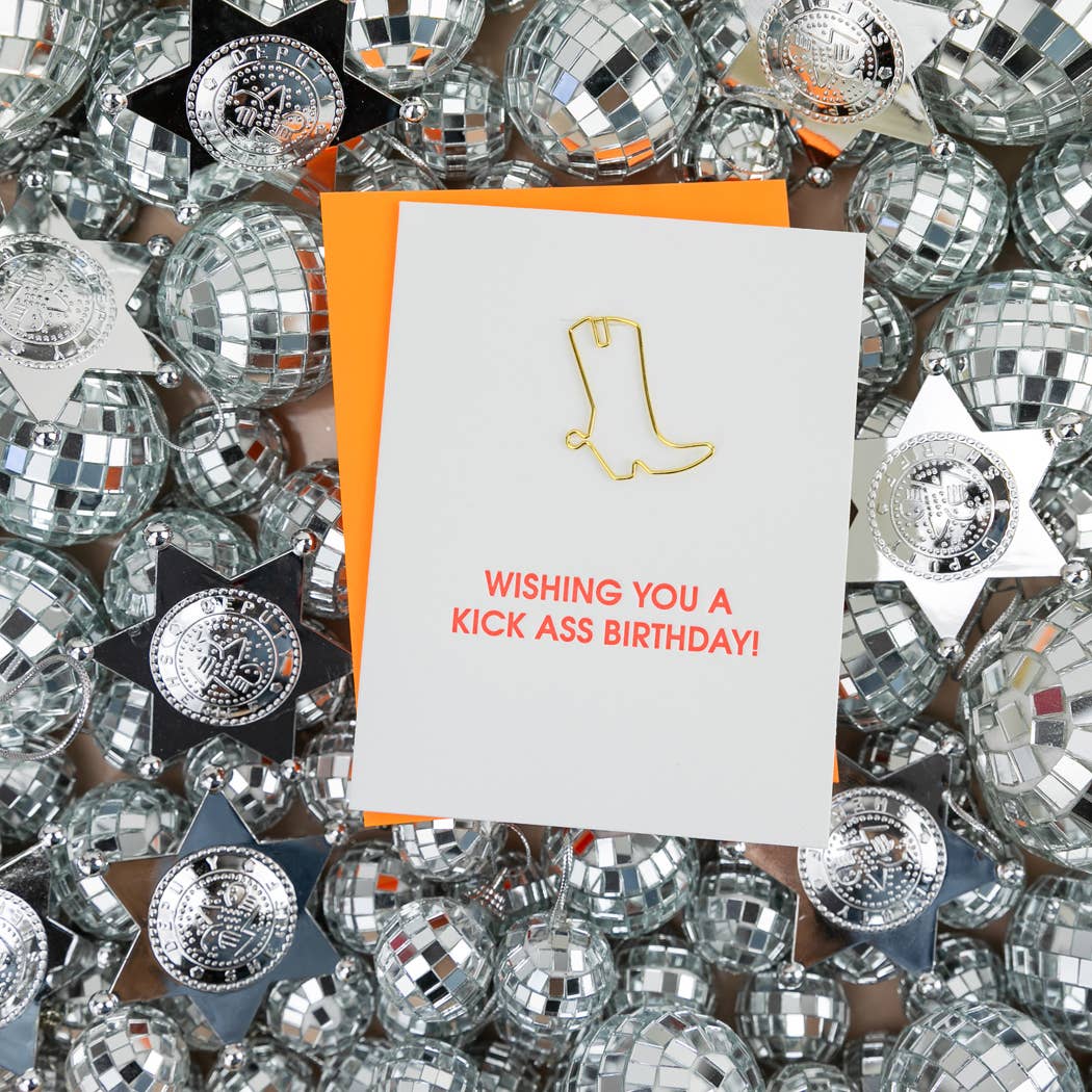 Birthday letterpress card with gold boot icon, red message, and orange envelope behind.