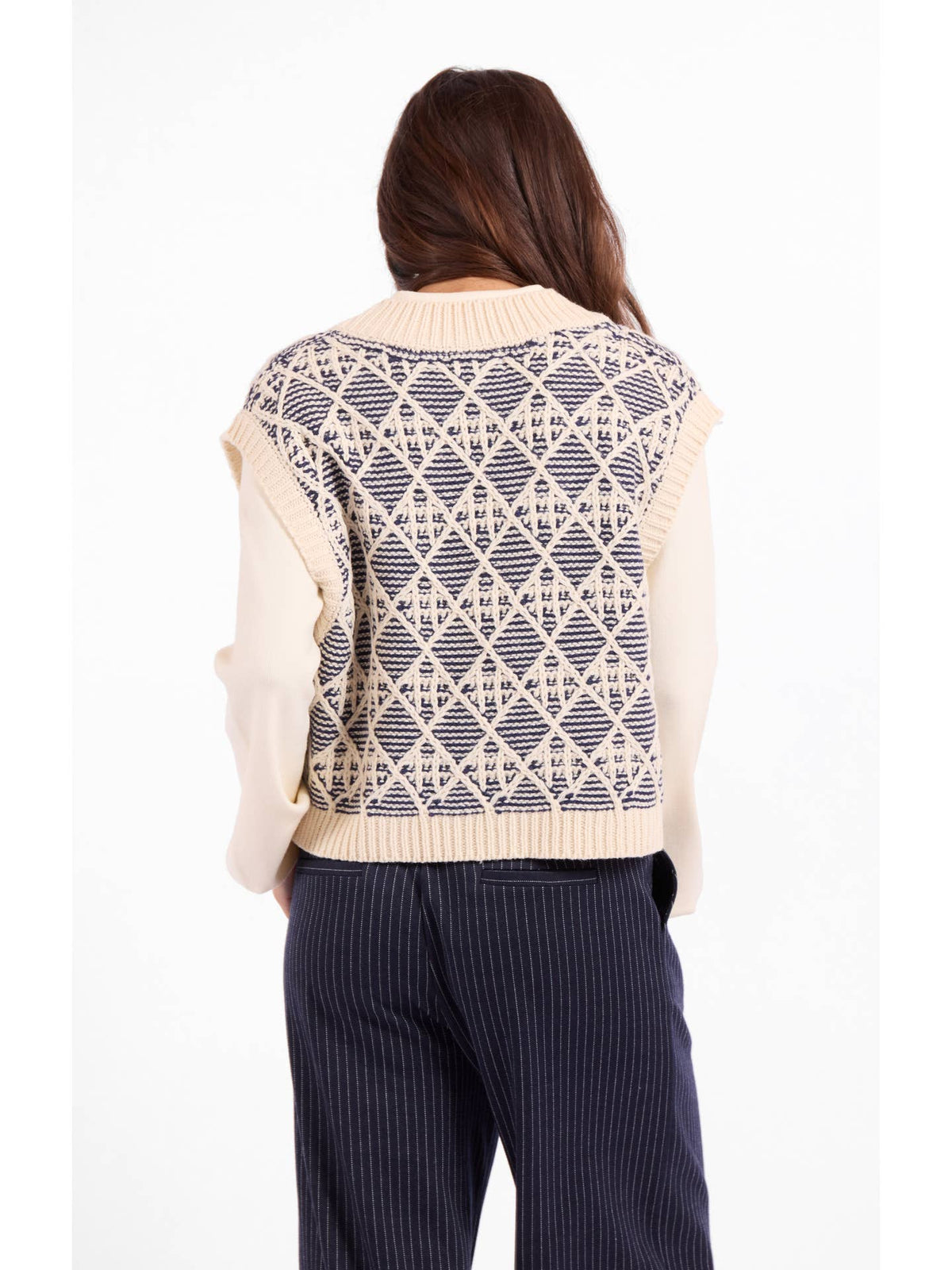Sleeveless sweater vest back with cream base and blue geometric diamond knit pattern