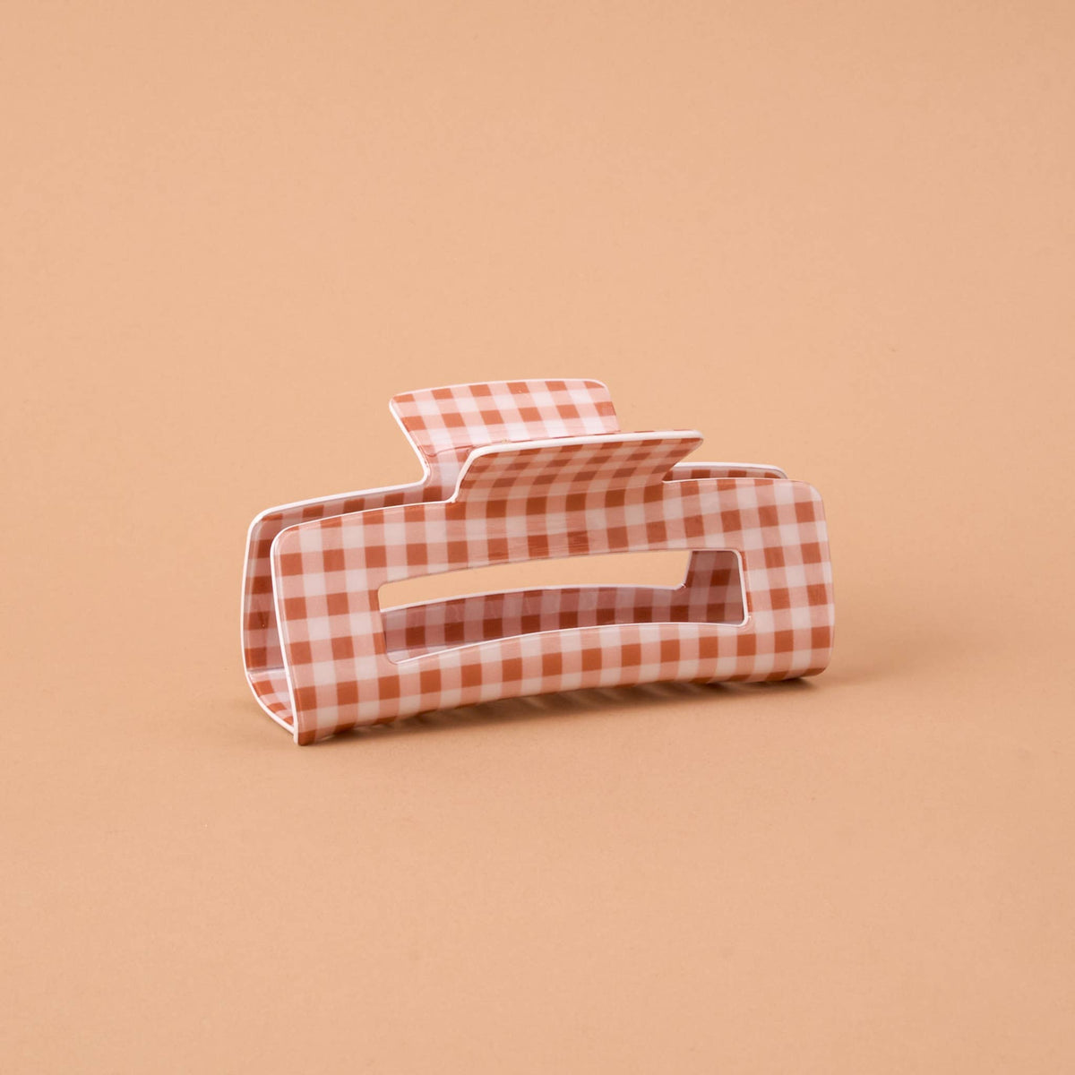 Orange-and-white gingham claw clip with teeth