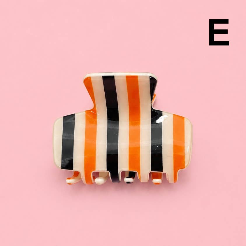 Orange, white, and black striped hair claw clip with four prongs