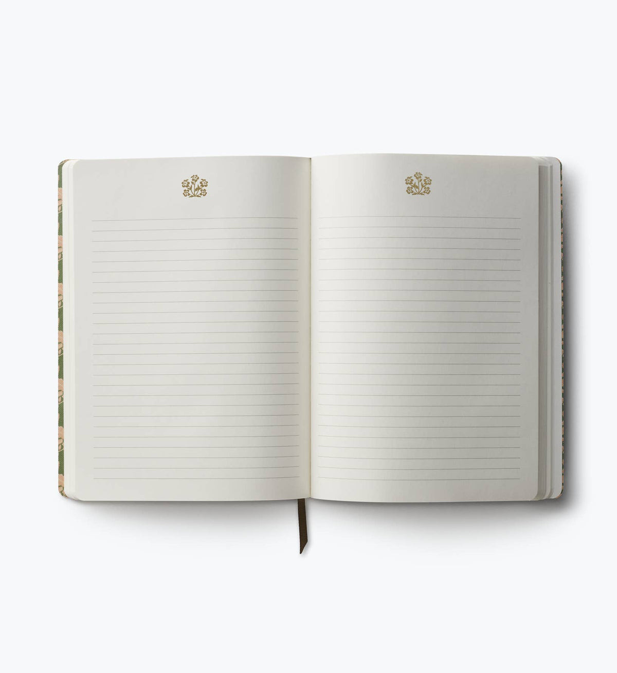 Open softcover journal with lined pages and small gold emblem