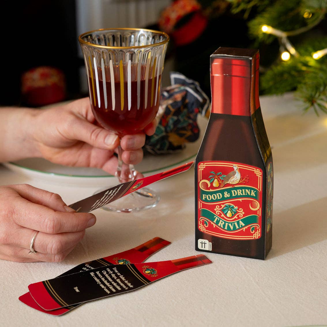 Food & Drink Trivia bottle pack with red drink cards being played