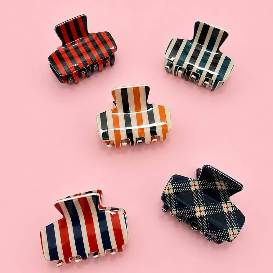 Set of hair claw clips with striped and plaid designs in red, navy, and green