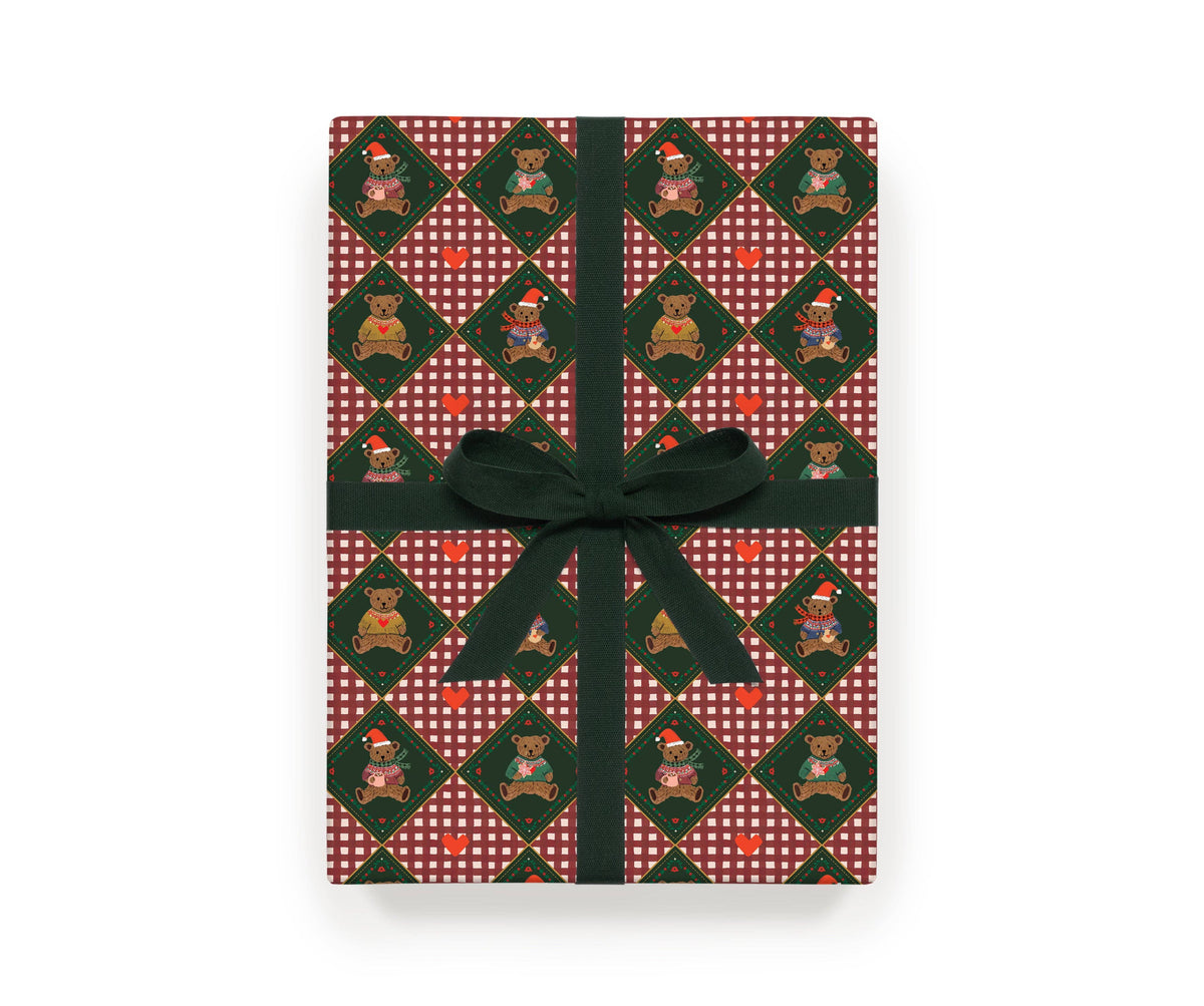Christmas gift wrap sheet with red plaid bear pattern and green ribbon bow