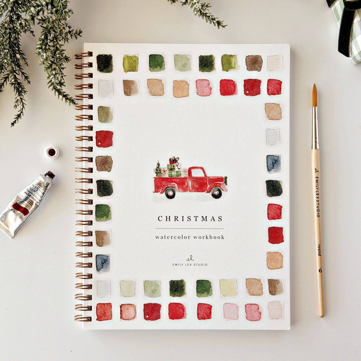 Christmas watercolor workbook cover with red truck, palette squares, and “CHRISTMAS” title