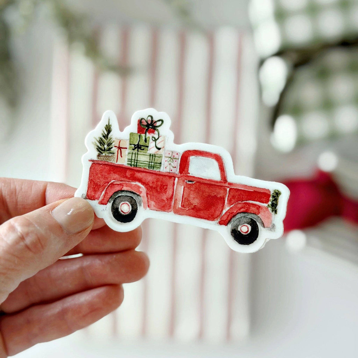 Christmas truck sticker with red pickup hauling wrapped gifts and a tree topper