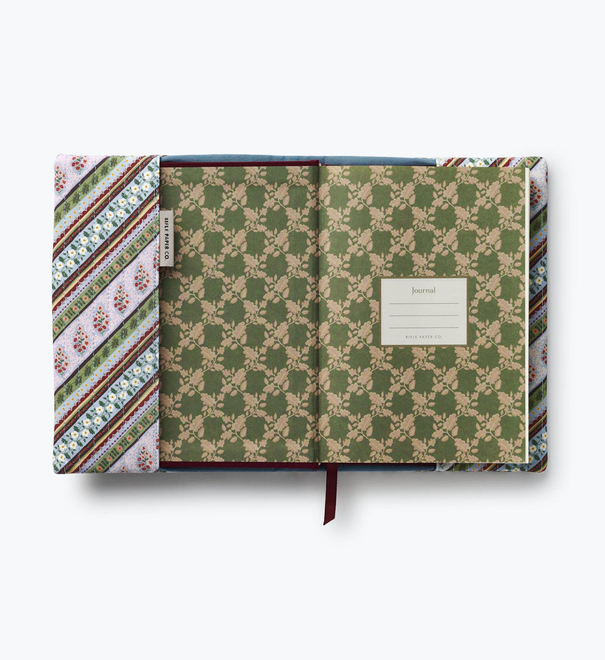 Open quilted journal with striped paisley cover and green floral interior pocket