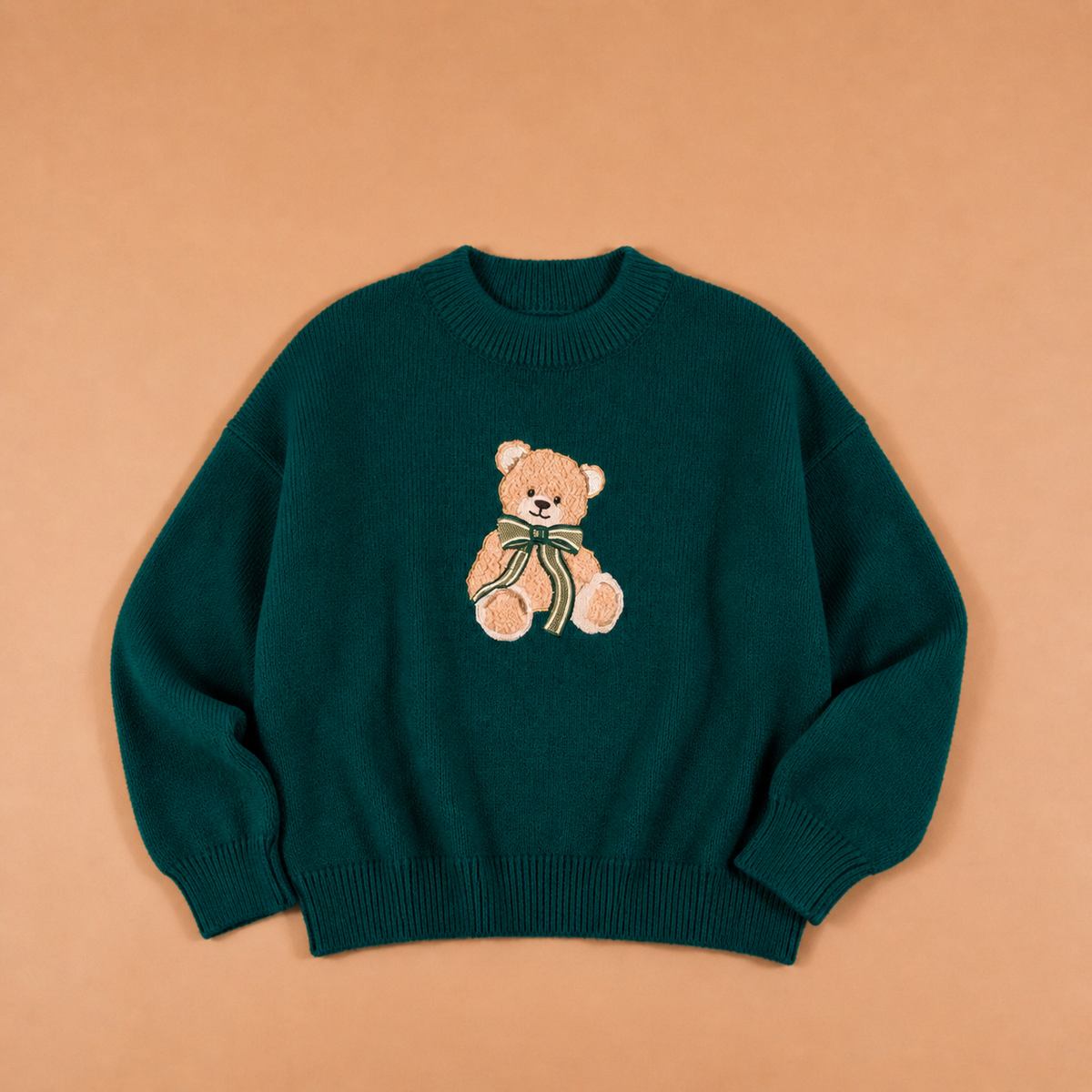 Teal crewneck sweater with teddy bear graphic applique and ribbed cuffs and hem