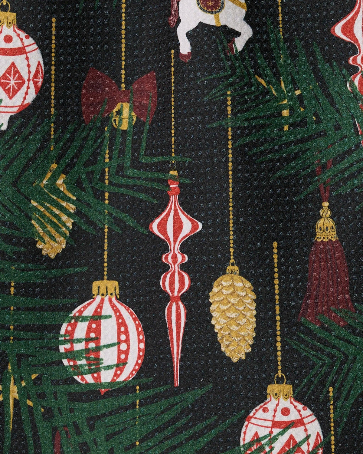 Mini towel close-up with hanging ornament and tree pattern in red, gold, and green