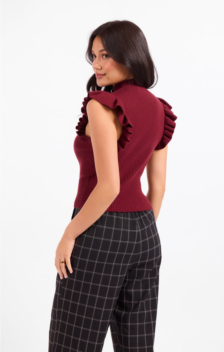 Burgundy mockneck ribbed tank sweater with ruffled shoulders, side view