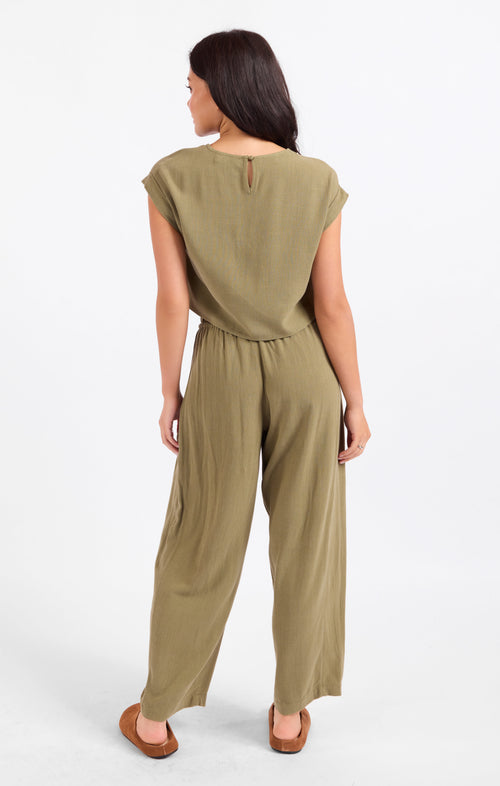 Olive green back view of cuffed short-sleeve top with crew neck