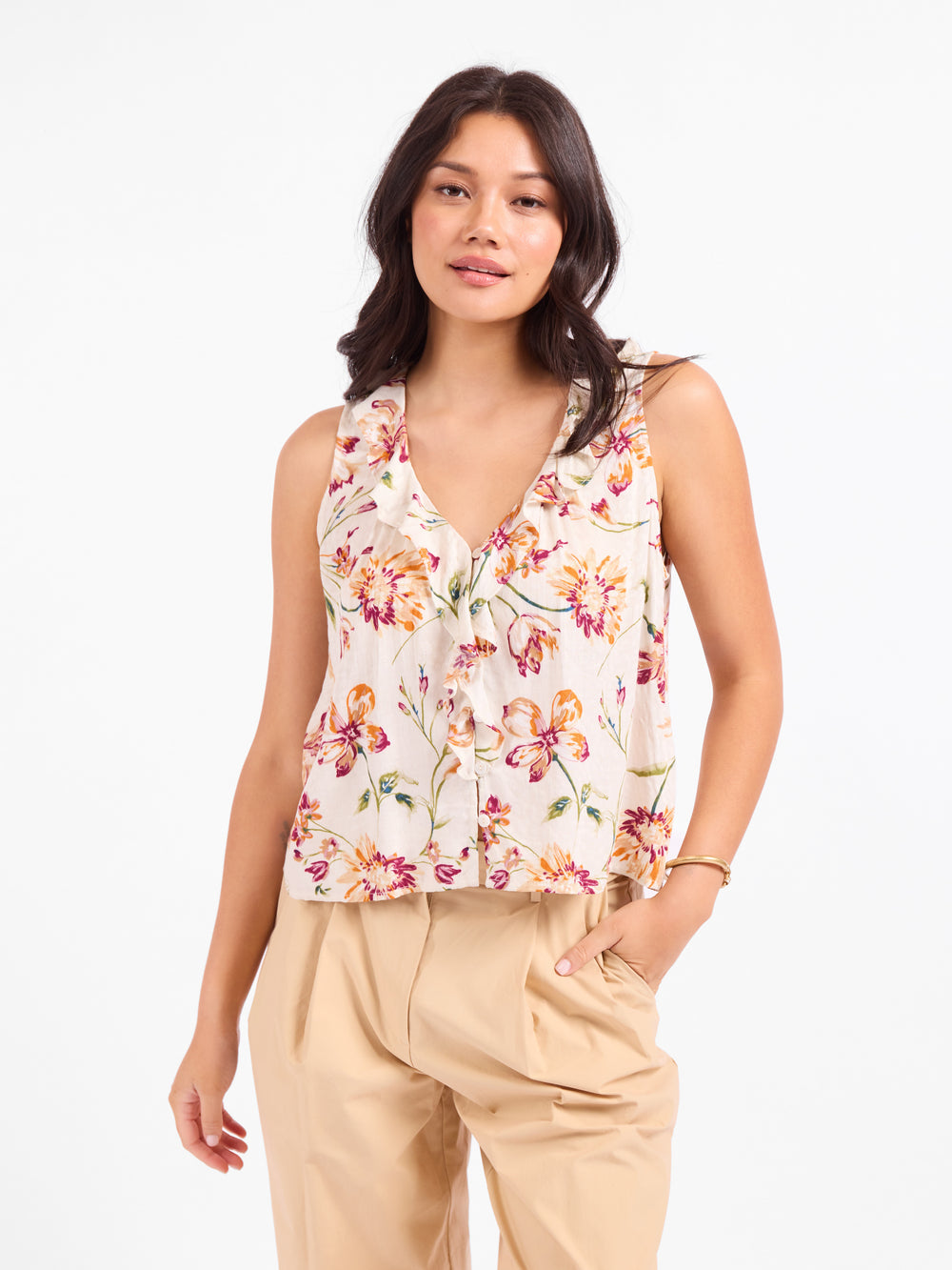 Floral sleeveless V-neck top with button front and ruffled trim on light base