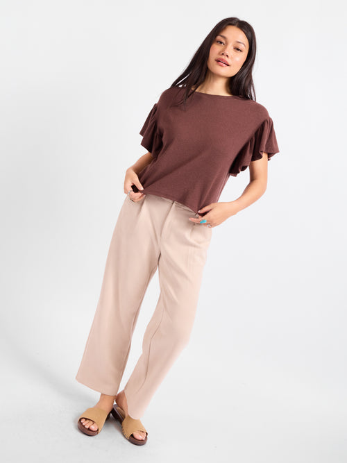 Dark brown ruffle-sleeve crew top with draped shoulders and relaxed hem