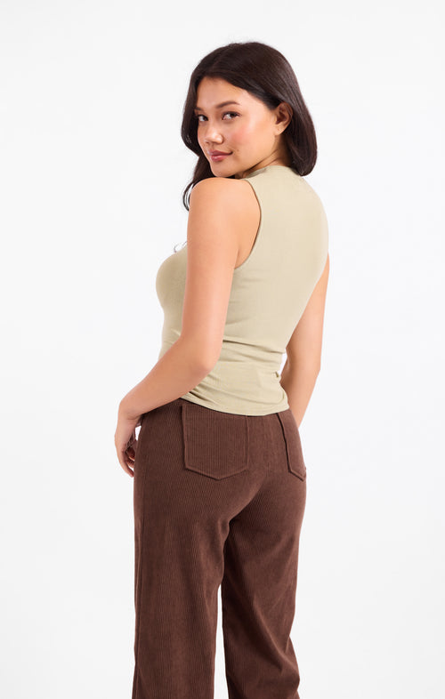 Cream mock neck sleeveless knit tank with ruched waist and fitted shape