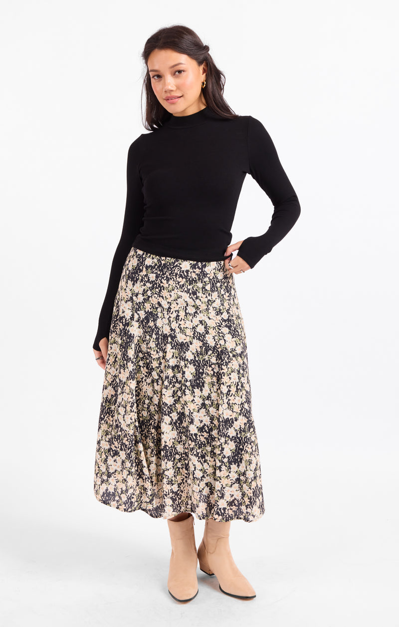 Black rib knit turtleneck top, long sleeves and fitted silhouette.