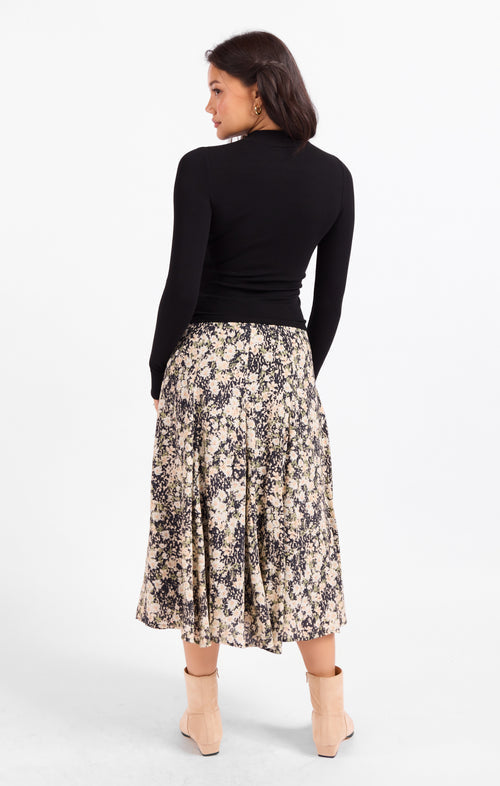 Black fitted knit top with high neckline and long sleeves, back view.