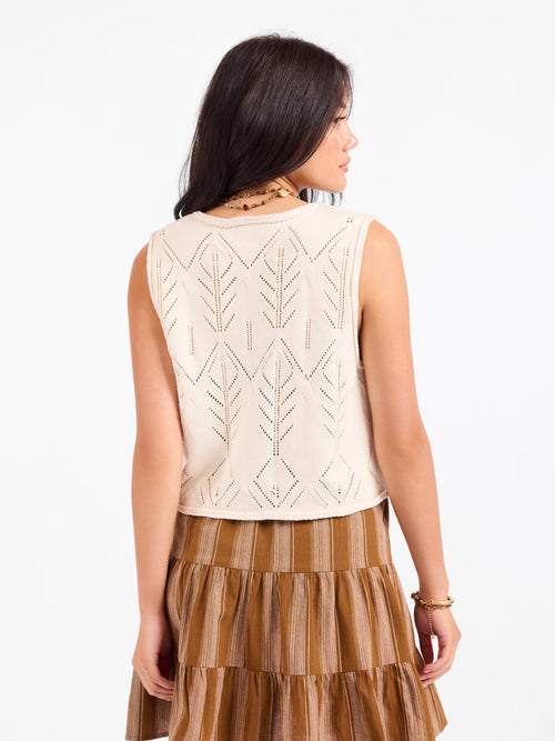 Cream pointelle knit sweater vest with geometric back pattern, sleeveless cut