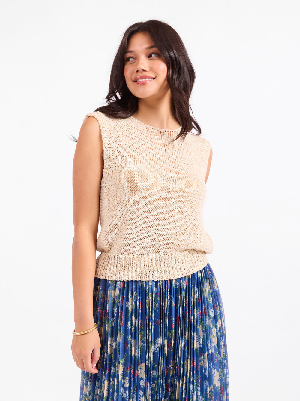 Oatmeal sleeveless knit sweater vest with round neckline and ribbed hem.