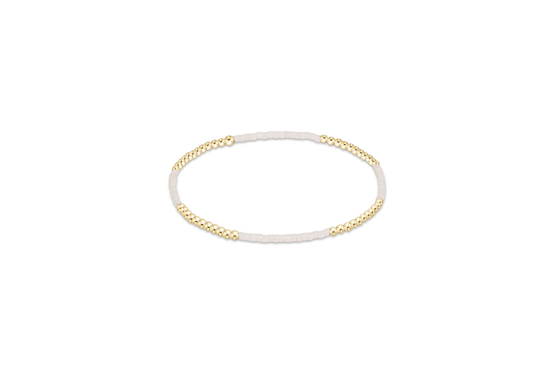 Gold-tone beaded bracelet with tiny round accents and adjustable chain