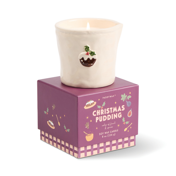 Cream ceramic candle with exposed wick on purple Christmas pudding themed base