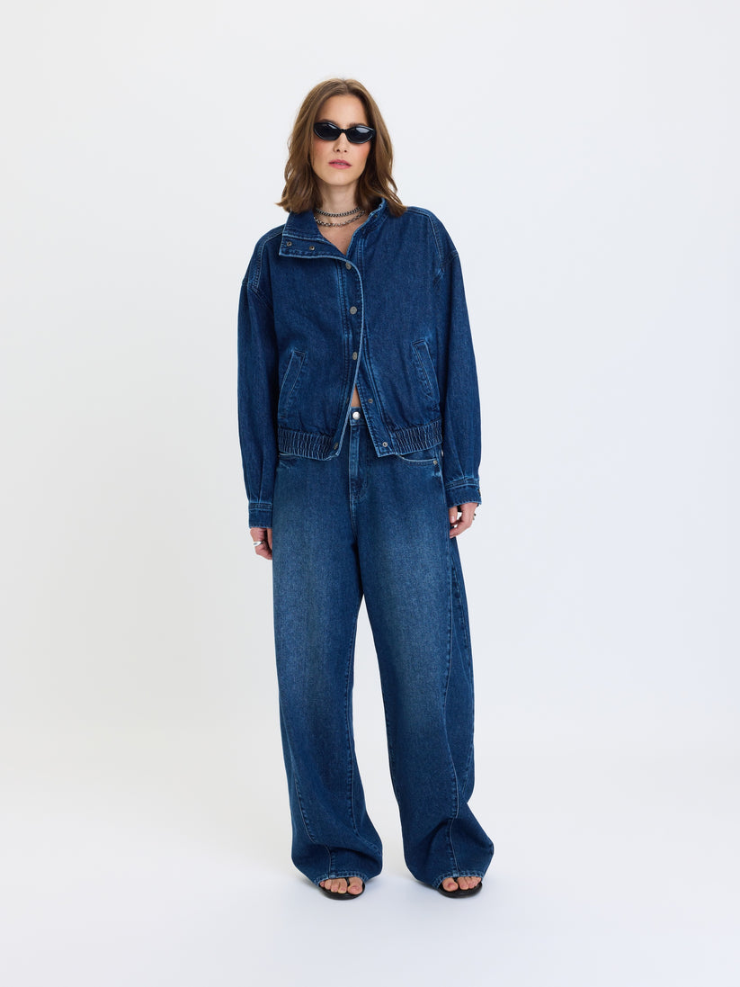 Blue denim funnel-neck jacket with snap front and front pockets, relaxed fit