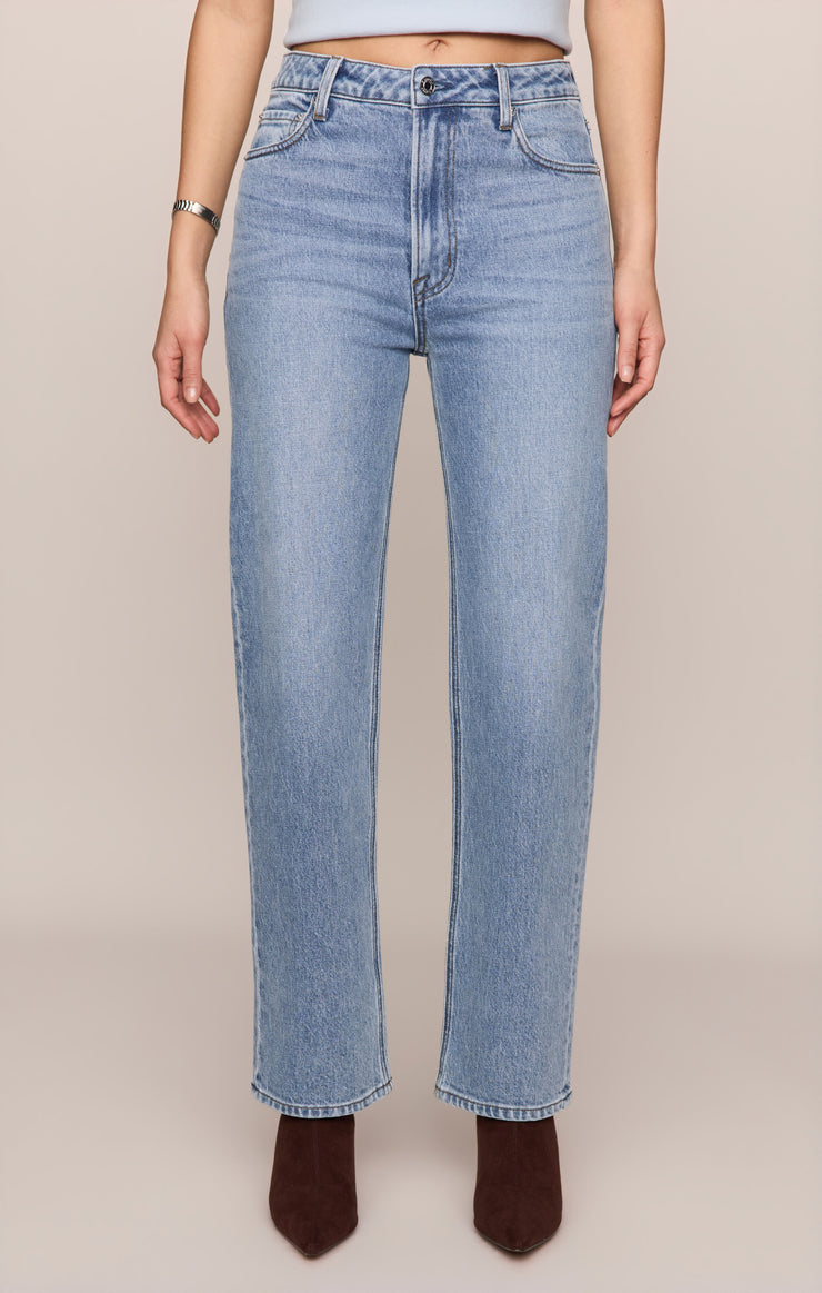 High-rise straight jeans in light wash denim with front button and zipper fly.