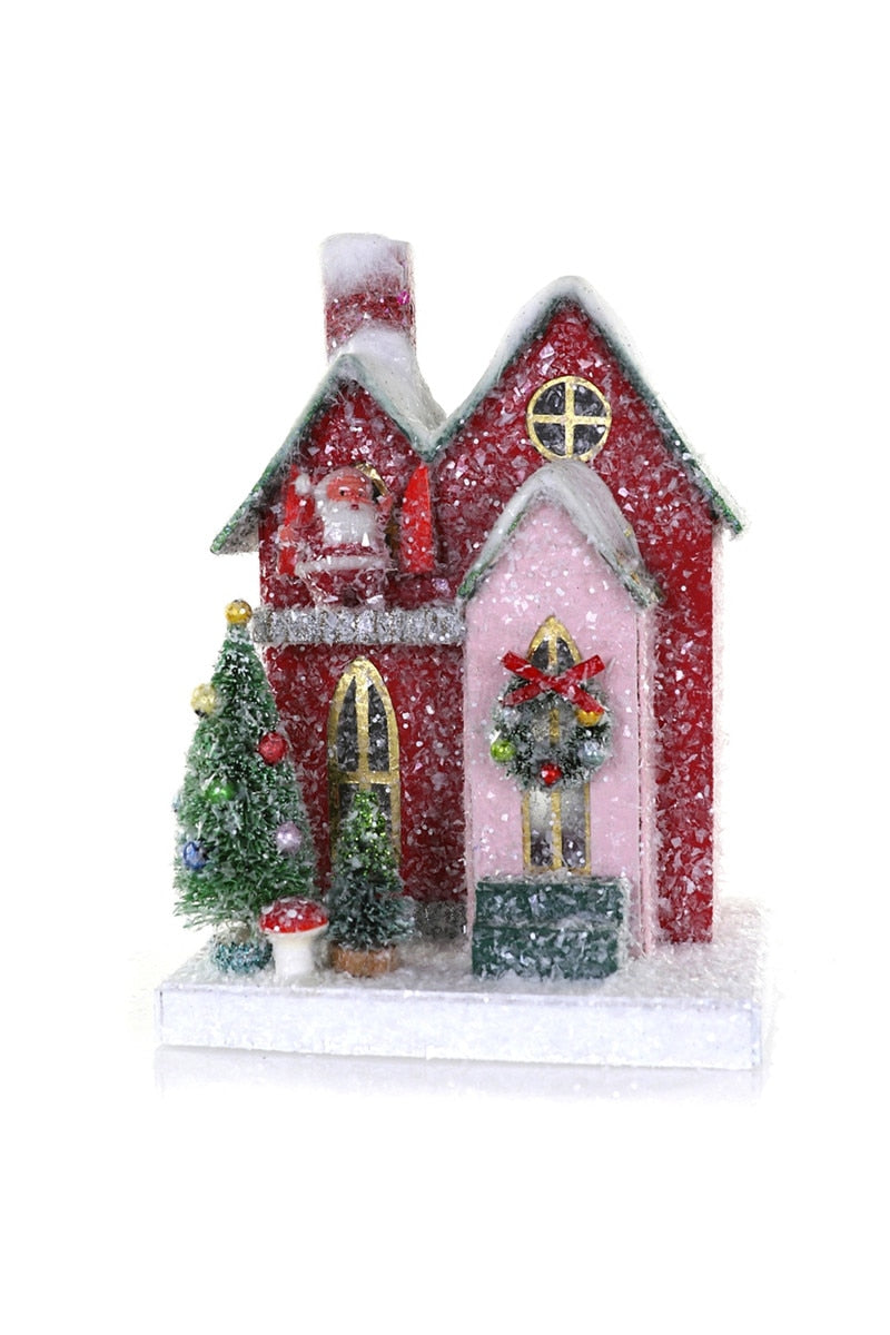 Red glitter house ornament with two doors and a snow-covered base