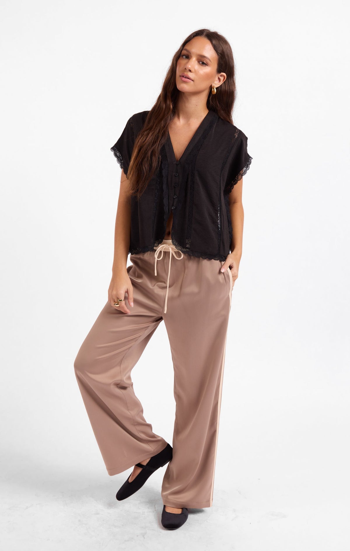 Black short-sleeve V-neck top with button placket and scalloped lace hem