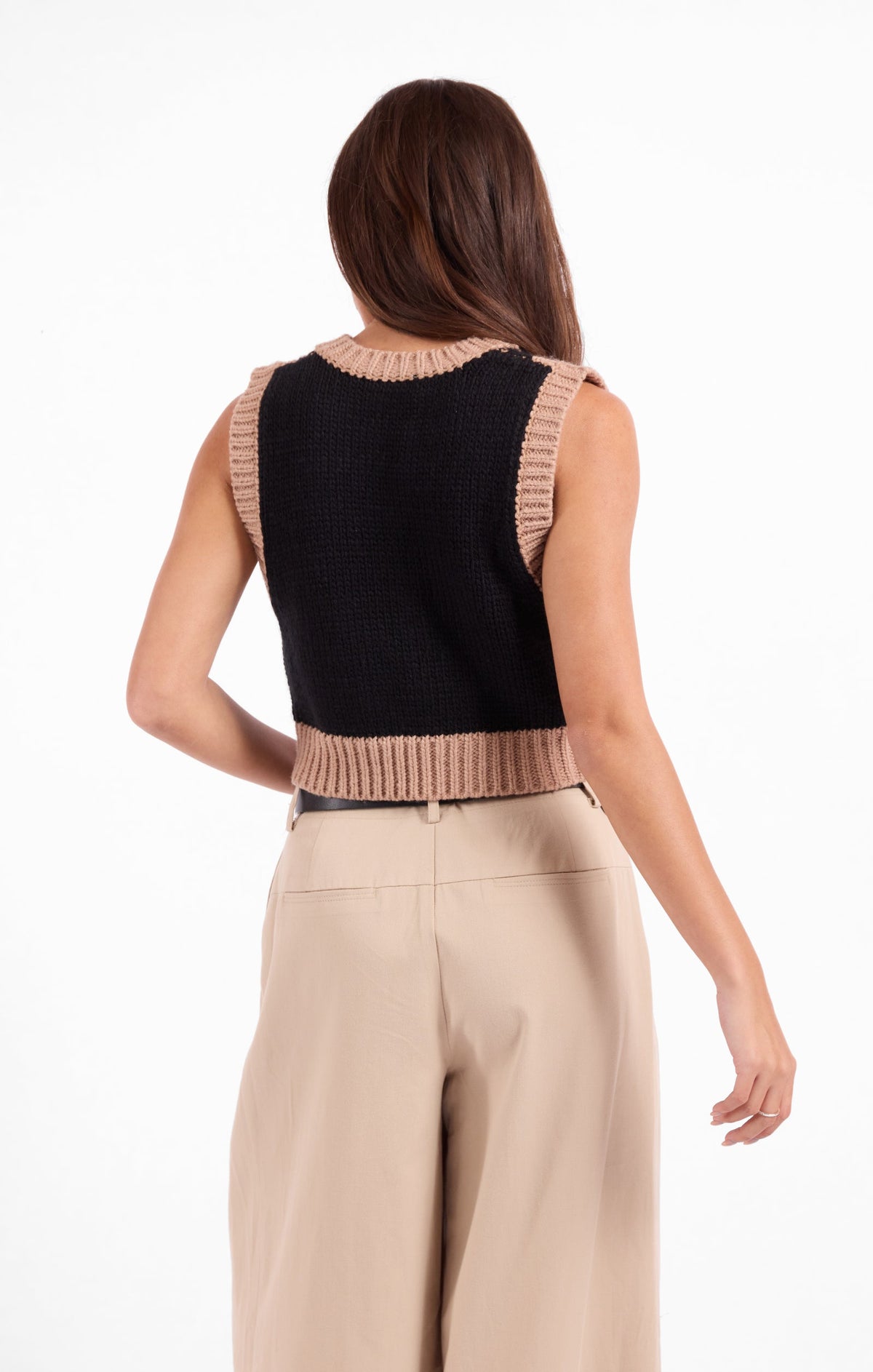Black sleeveless sweater vest back with beige ribbed yoke and hem