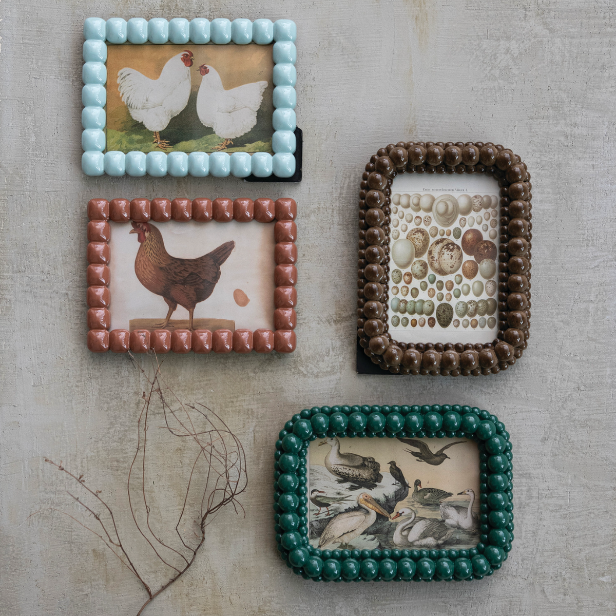 Four square bobbin photo frames with beaded borders and animal-themed inserts