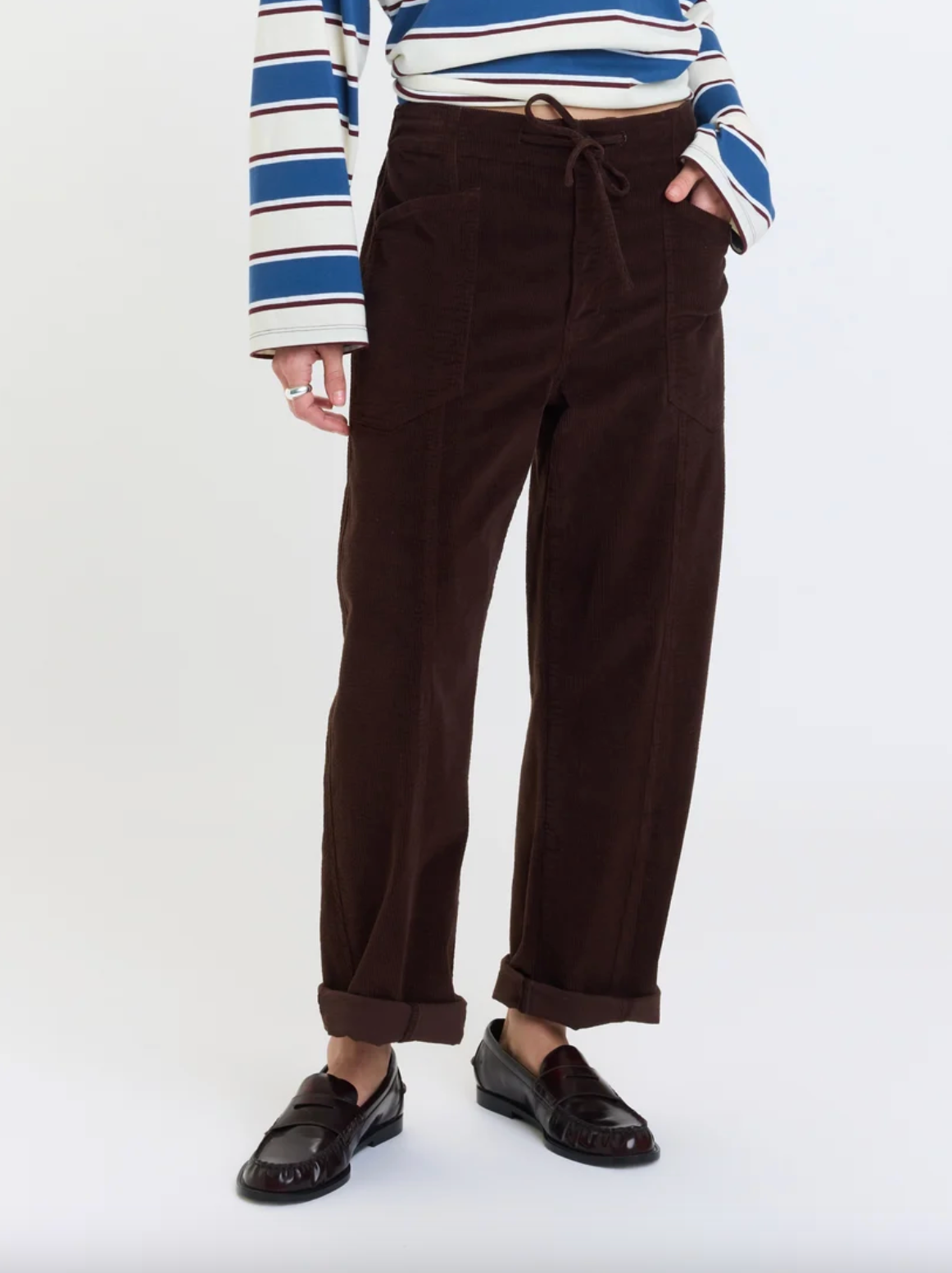 Dark brown barrel pants with drawstring waist, side pockets, cuffed hem