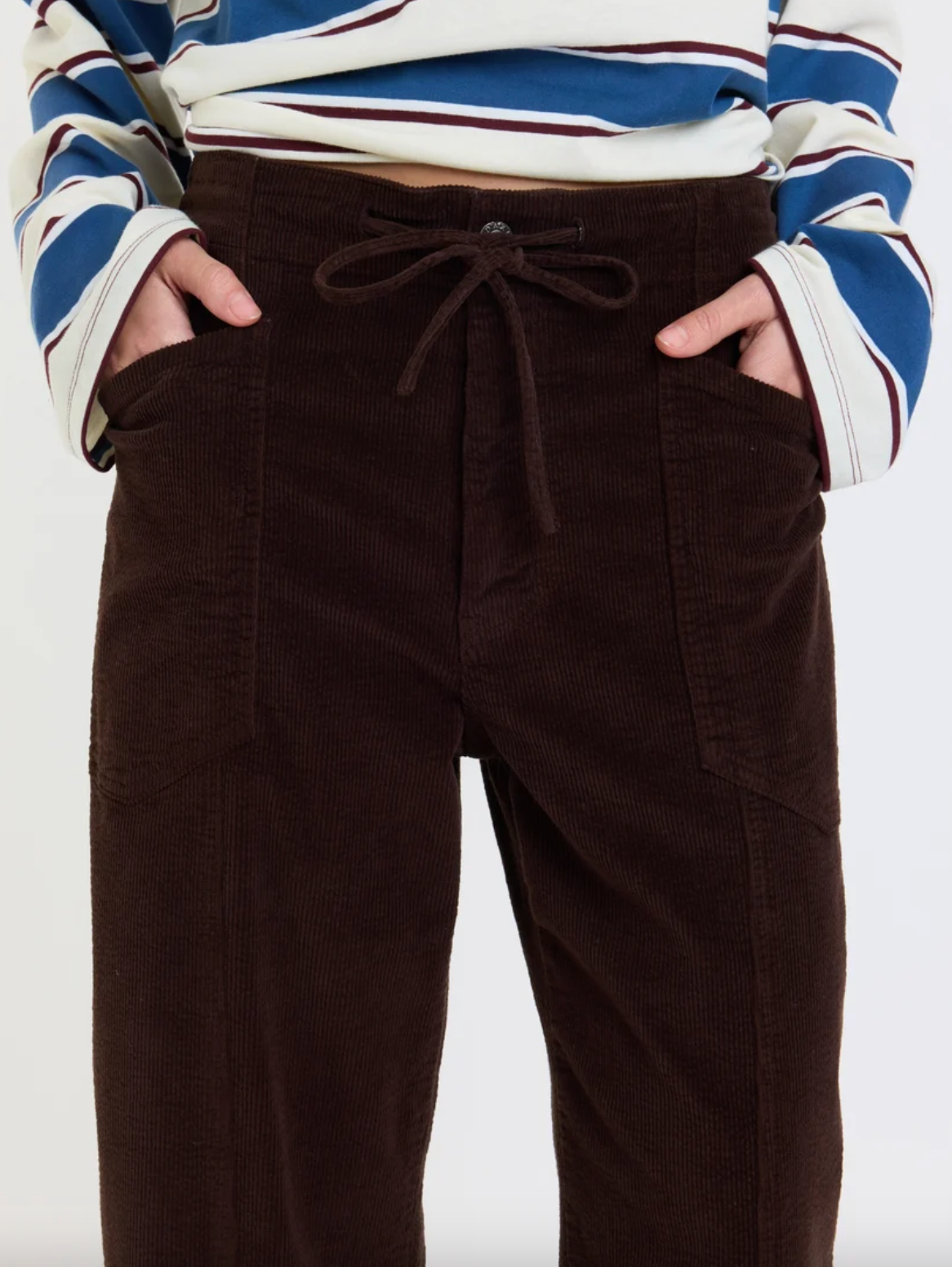 Dark brown drawstring waist barrel pants with seam detailing and pockets