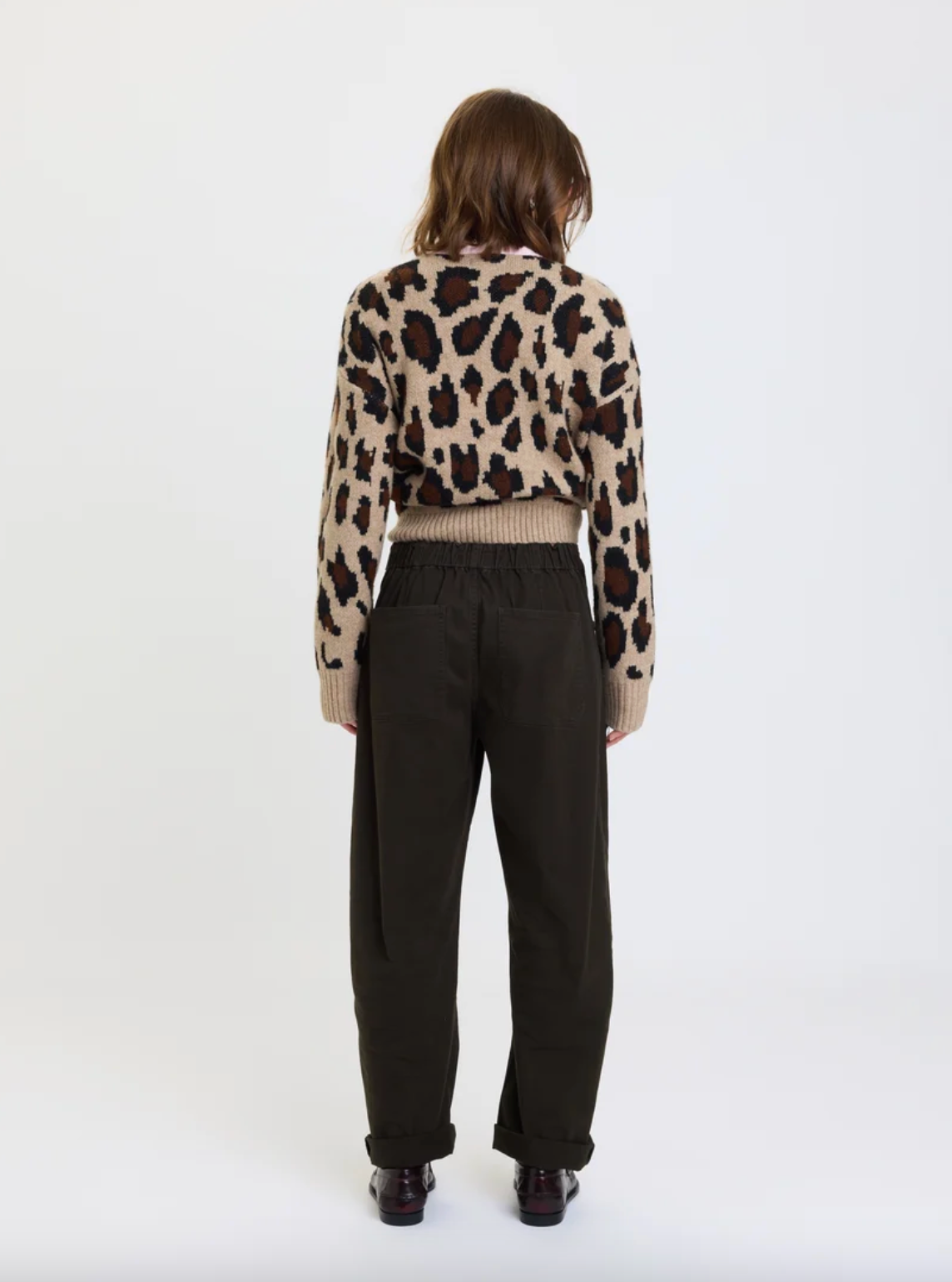 Back view of drawstring barrel pants with black elastic waist and relaxed barrel legs
