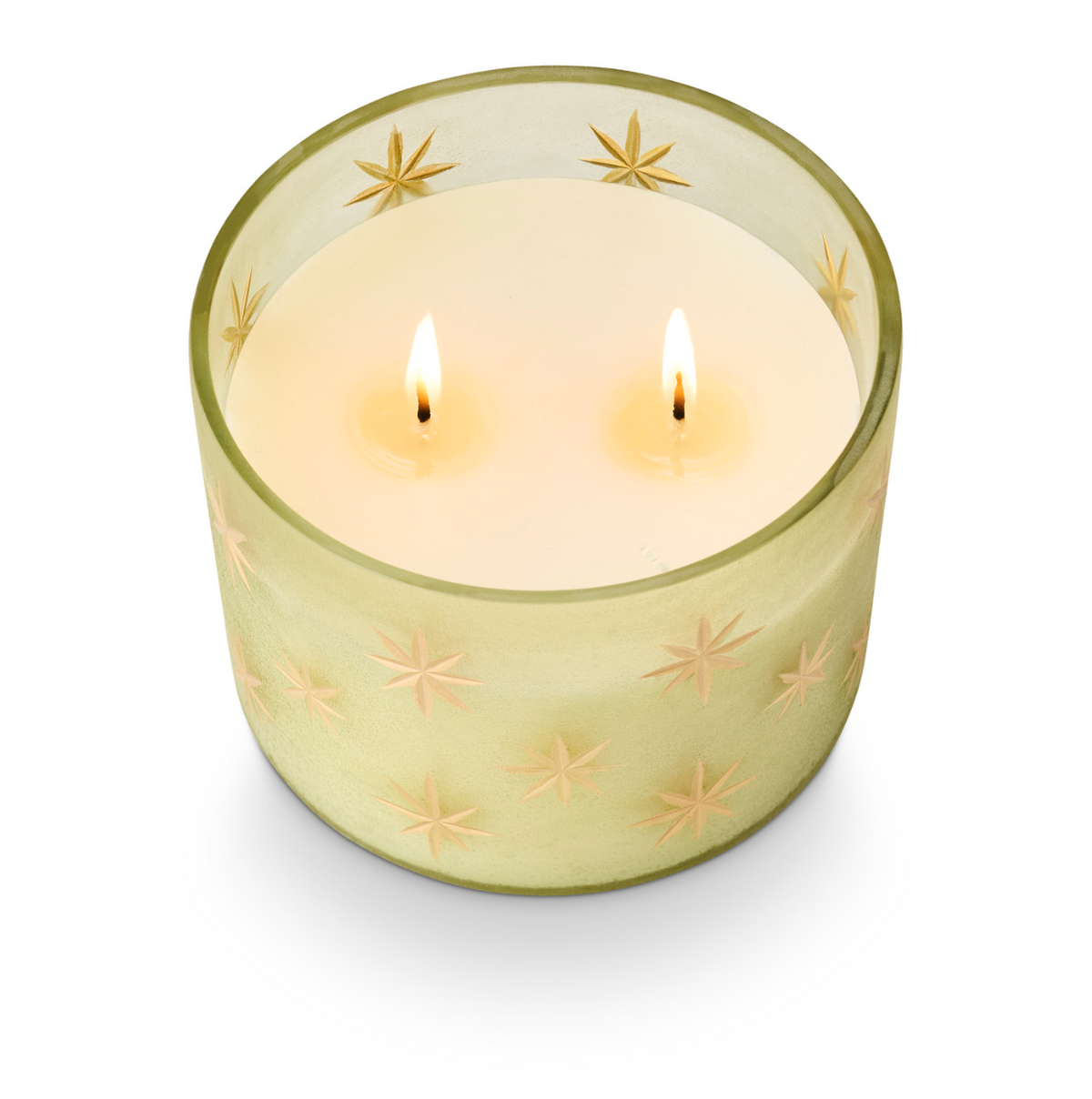 Frosted glass star candle in pale green with gold star pattern, lit with two flames