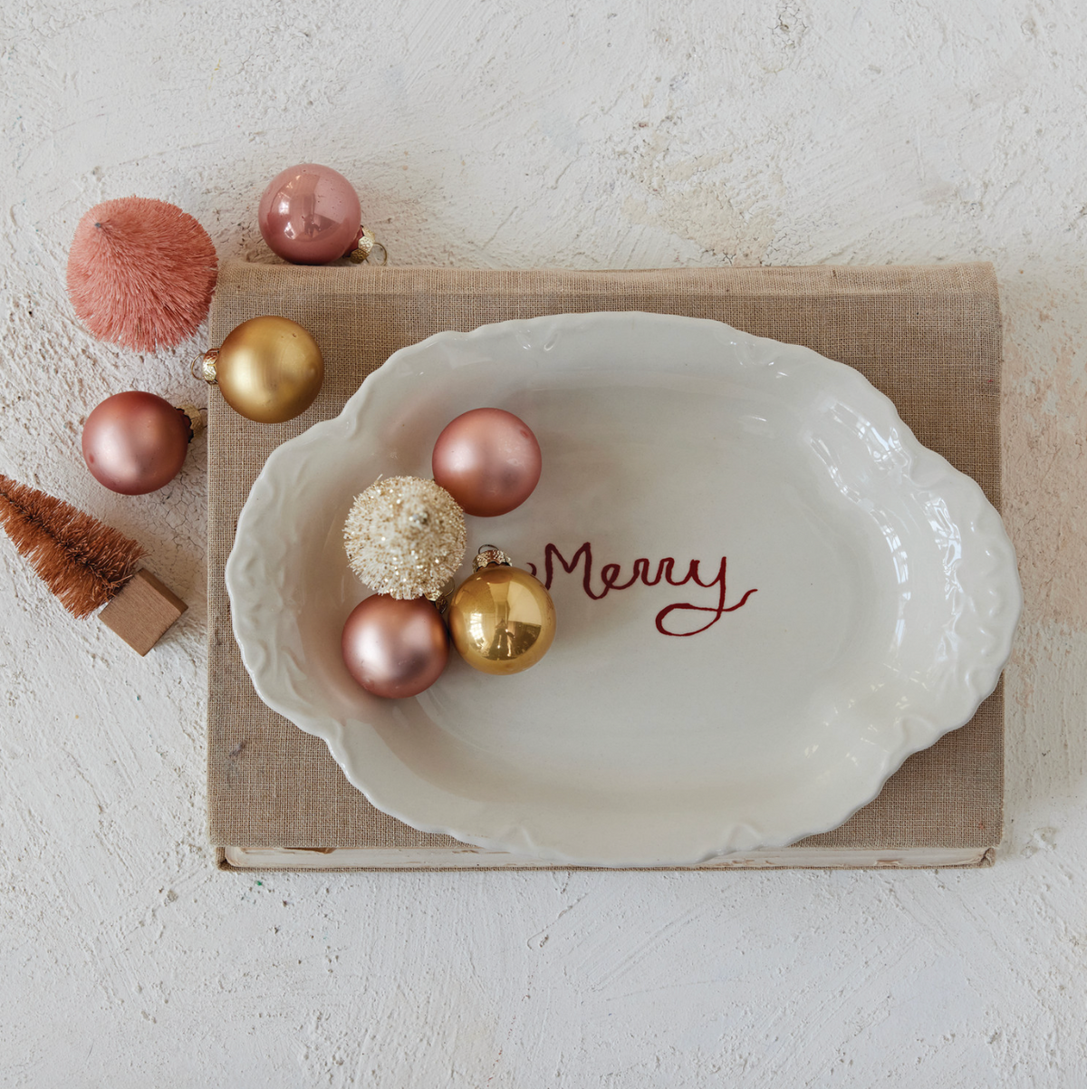 Cream stoneware scalloped platter, glossy finish, red 'Merry' text at center