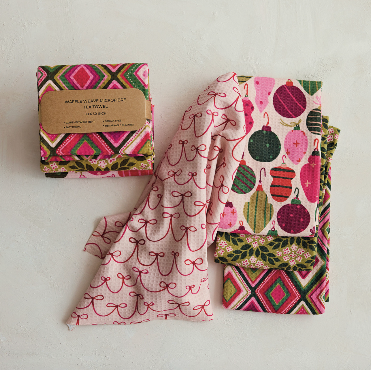 Recycled microfiber tea towel with pink bird and ornament print, folded waffle weave
