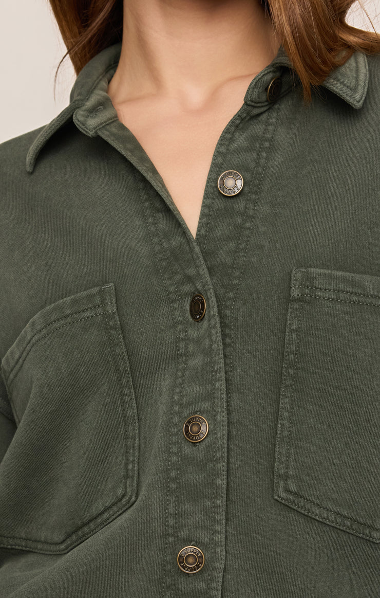 Dark olive knit jacket close-up with snap pockets and button placket