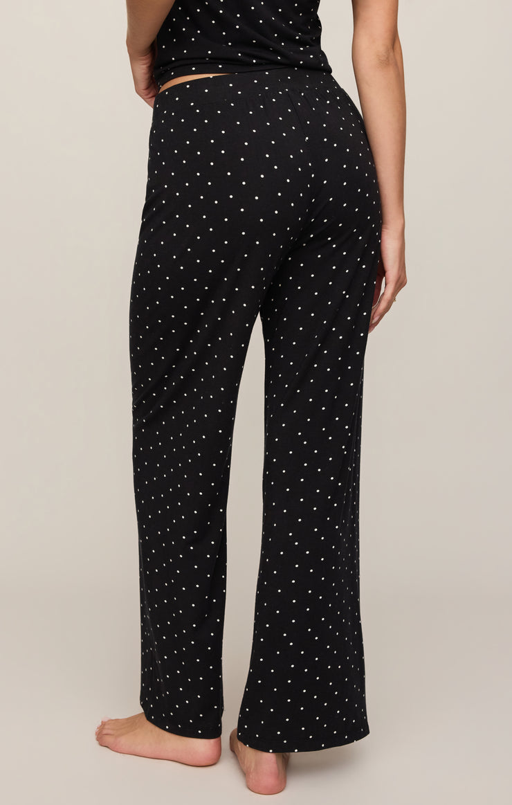 Dot-print wide-leg pants in black with scattered white dots, ankle-length