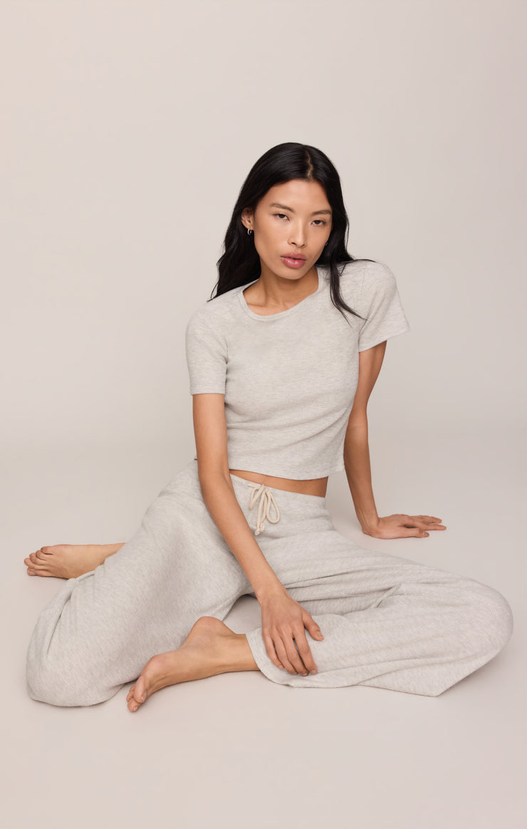 Light gray wide-leg thermal pants with drawstring waist, laid-back lounging pose